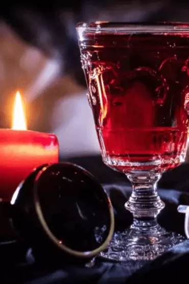 Red Halloween cocktail with candles